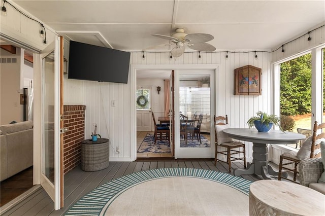 sunroom / solarium with a ceiling fan and visible vents