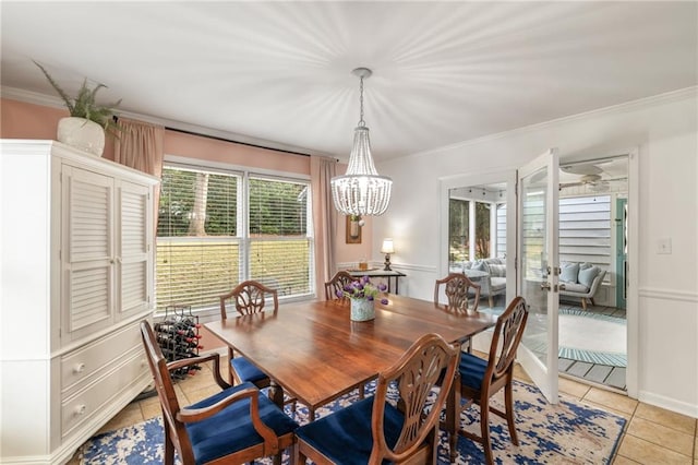 dining room with an inviting chandelier, crown molding, and light tile patterned flooring