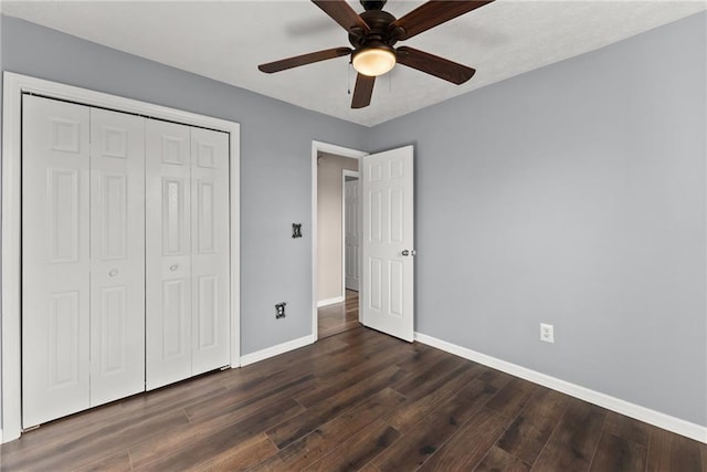 unfurnished bedroom with ceiling fan, dark hardwood / wood-style floors, and a closet