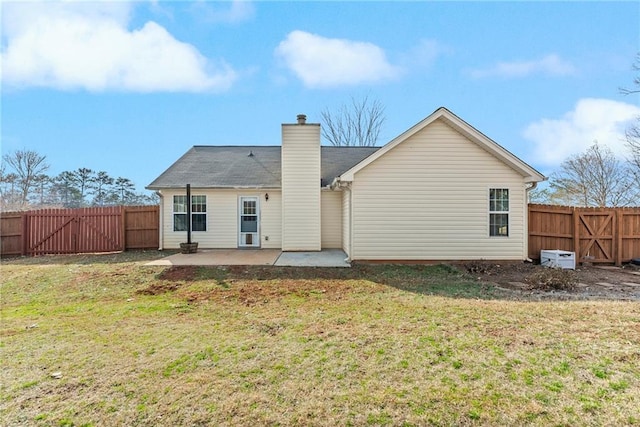 rear view of house featuring a yard and a patio area