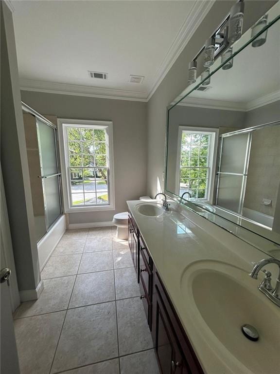 full bathroom with tile patterned floors, ornamental molding, toilet, and enclosed tub / shower combo