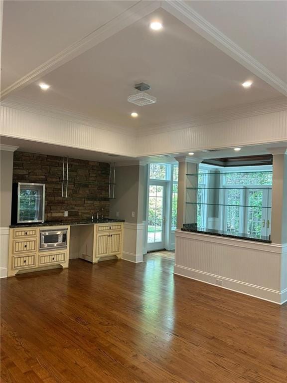 kitchen featuring crown molding, dark hardwood / wood-style floors, and stainless steel microwave