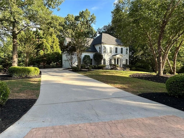 view of front of home with a garage and a front yard