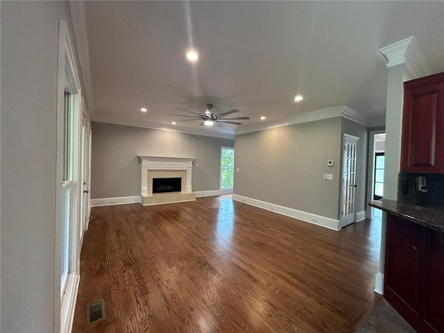 unfurnished living room with ornamental molding, dark hardwood / wood-style floors, and ceiling fan