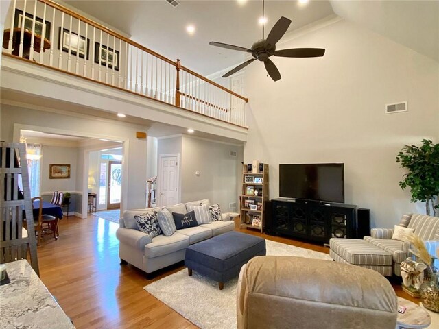 kitchen with pendant lighting, lofted ceiling, stainless steel dishwasher, light stone counters, and kitchen peninsula