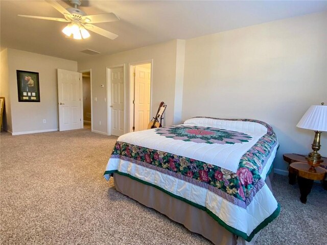 carpeted bedroom featuring ceiling fan and vaulted ceiling