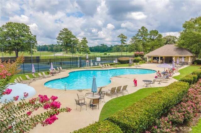 view of swimming pool featuring a yard and a patio area