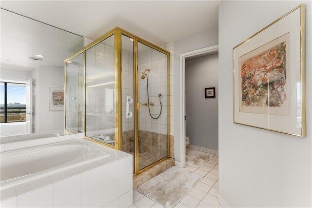 2660 Peachtree Rd NW Unit 18G, Atlanta, GA 30305 - full bathroom with a shower stall, tile patterned floors, toilet, a garden tub, and baseboards