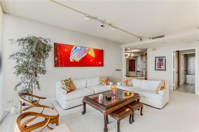 2660 Peachtree Rd NW Unit 18G, Atlanta, GA 30305 - carpeted living room with a chandelier