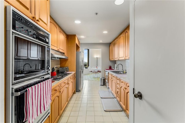 2660 Peachtree Rd NW Unit 18G, Atlanta, GA 30305 - kitchen featuring freestanding refrigerator, multiple ovens, under cabinet range hood, backsplash, and recessed lighting