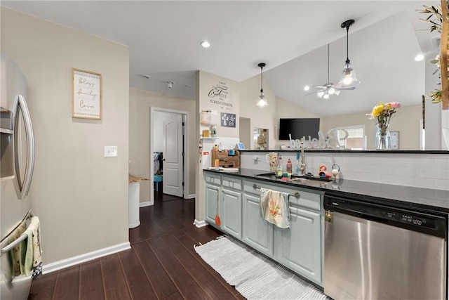 2691 Bald Cypress Dr, Braselton, GA 30517 - kitchen featuring stainless steel appliances, dark countertops, dark wood-style flooring, a ceiling fan, and vaulted ceiling