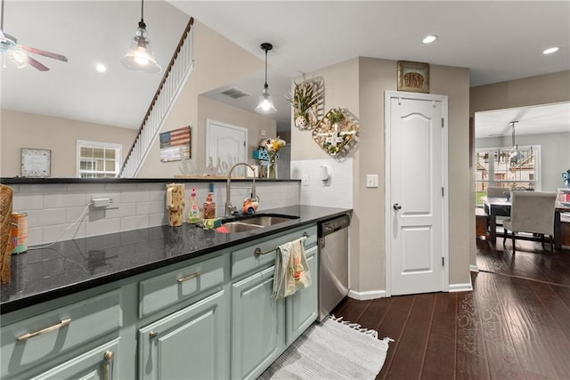 2691 Bald Cypress Dr, Braselton, GA 30517 - kitchen with stainless steel dishwasher, backsplash, ceiling fan, dark wood finished floors, and hanging light fixtures