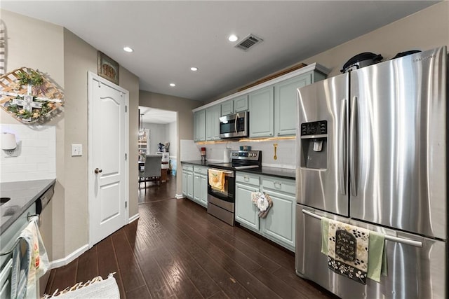 2691 Bald Cypress Dr, Braselton, GA 30517 - kitchen featuring appliances with stainless steel finishes, recessed lighting, backsplash, dark wood-style floors, and dark countertops