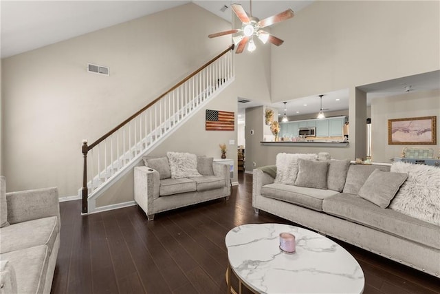 2691 Bald Cypress Dr, Braselton, GA 30517 - living room featuring stairs, a ceiling fan, high vaulted ceiling, and dark wood-style floors