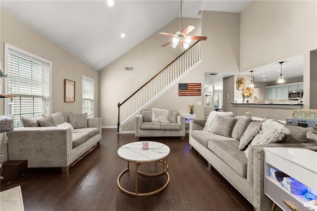 2691 Bald Cypress Dr, Braselton, GA 30517 - living area with high vaulted ceiling, ceiling fan, dark wood-style flooring, and stairs