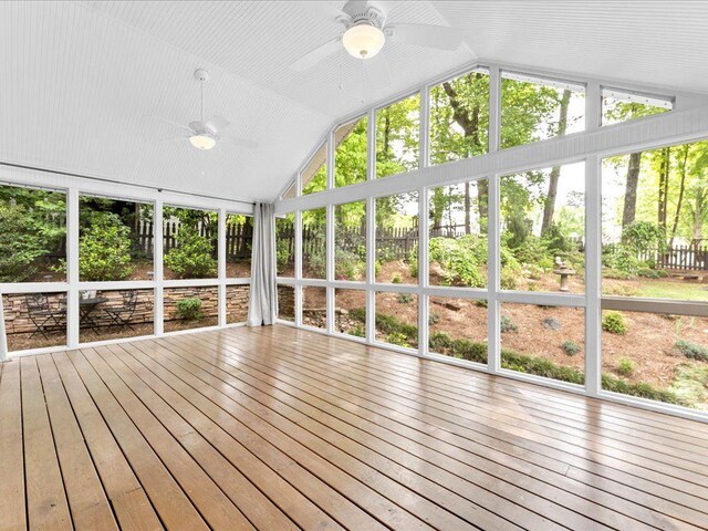 unfurnished sunroom featuring ceiling fan, lofted ceiling, and healthy amount of natural light