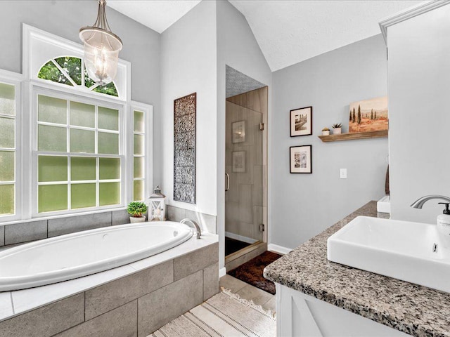 full bathroom with a sink, a stall shower, tile patterned flooring, a bath, and lofted ceiling