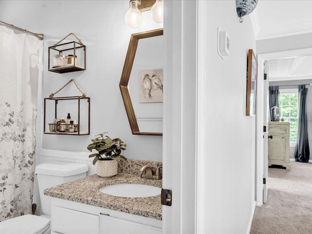 full bathroom with toilet, vanity, crown molding, and a shower with curtain