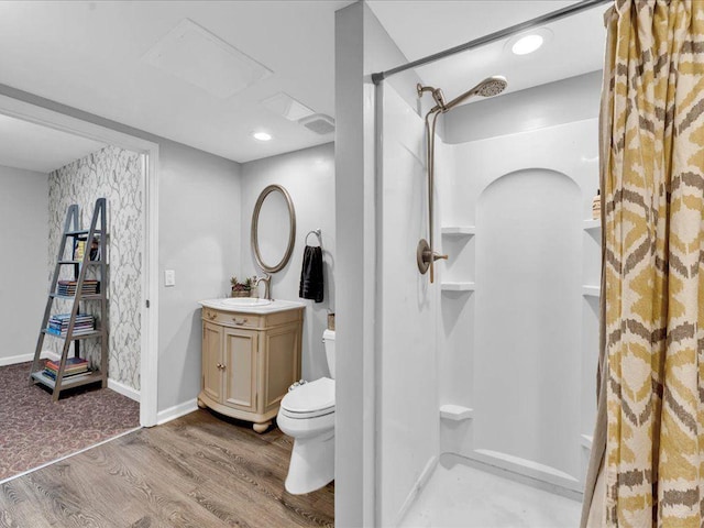 5625 Brookstone Dr NW, Acworth, GA 30101 - full bathroom with a shower, wood finished floors, toilet, vanity, and baseboards