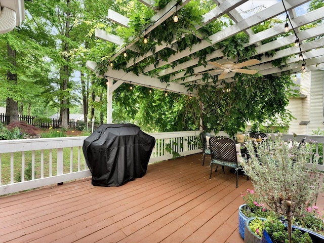 wooden terrace featuring a pergola, fence, grilling area, and ceiling fan