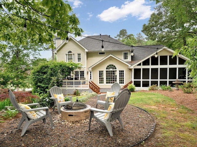 5625 Brookstone Dr NW, Acworth, GA 30101 - back of house featuring a fire pit, a sunroom, a deck, a chimney, and a shingled roof