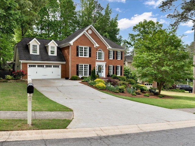 view of front of home featuring brick siding, concrete driveway, and a front yard