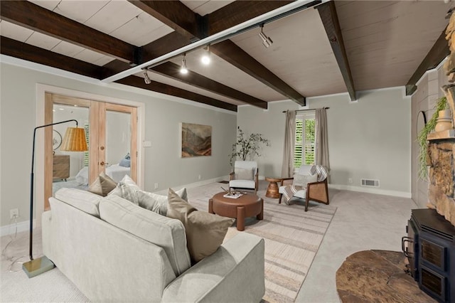 467 Liberty Grove Rd, Alpharetta, GA 30004 - living area featuring carpet flooring, beam ceiling, a wood stove, baseboards, and french doors