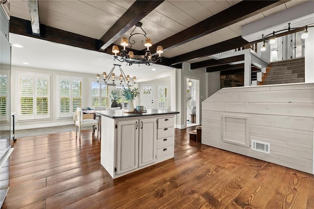467 Liberty Grove Rd, Alpharetta, GA 30004 - unfurnished dining area with a chandelier, dark wood finished floors, stairs, wooden ceiling with exposed beams, and baseboards