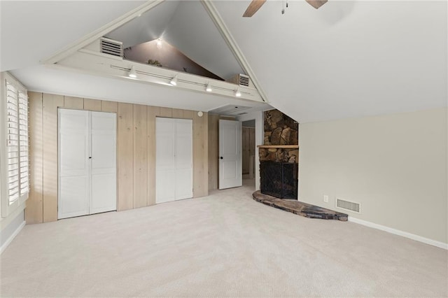 467 Liberty Grove Rd, Alpharetta, GA 30004 - unfurnished living room with a ceiling fan, lofted ceiling, carpet floors, a stone fireplace, and wood walls