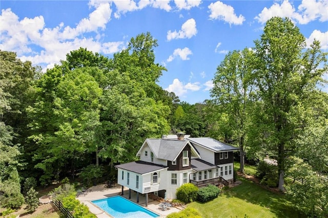467 Liberty Grove Rd, Alpharetta, GA 30004 - rear view of property featuring an outdoor pool, a lawn, a forest view, and a patio area