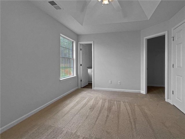 45 Hampton Dr, Cartersville, GA 30121 - unfurnished bedroom with visible vents, a walk in closet, baseboards, carpet floors, and a raised ceiling