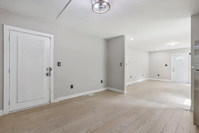 spare room with light hardwood / wood-style flooring