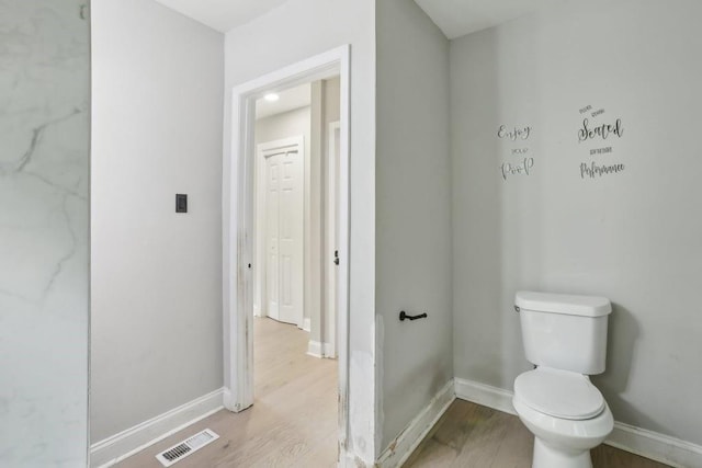 bathroom featuring hardwood / wood-style flooring and toilet