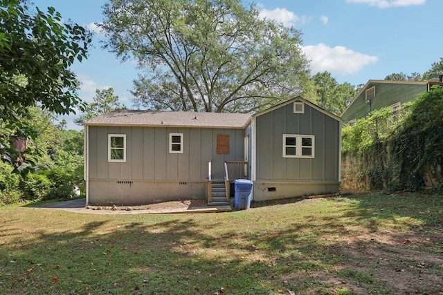 rear view of house with a lawn