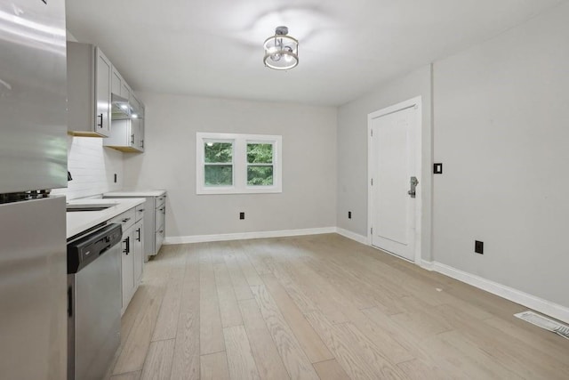 kitchen with stainless steel appliances, light hardwood / wood-style flooring, and white cabinets