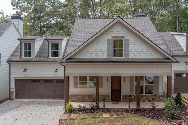 view of front facade with a porch and a garage