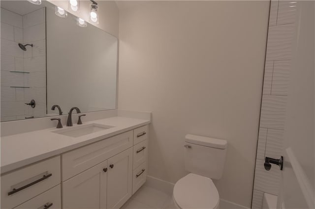 bathroom featuring tile patterned floors, vanity, and toilet