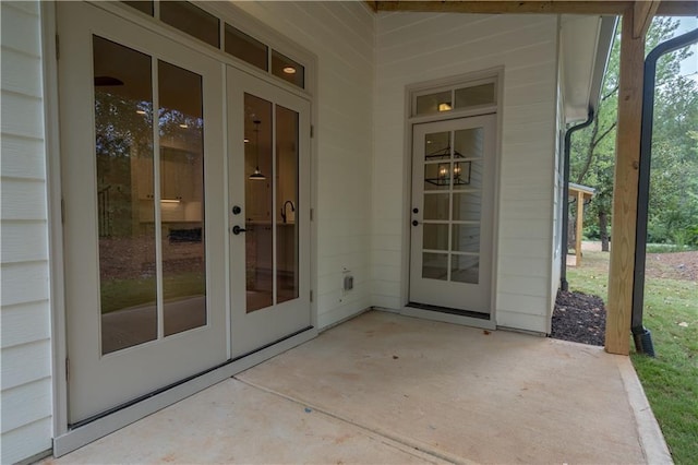 view of exterior entry with french doors and a patio