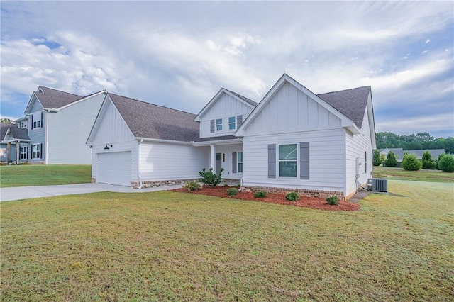 view of front of home featuring central AC, a garage, and a front lawn