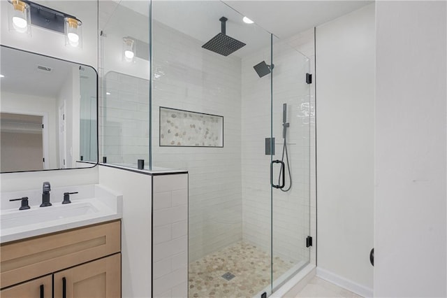 bathroom featuring visible vents, a shower stall, and vanity