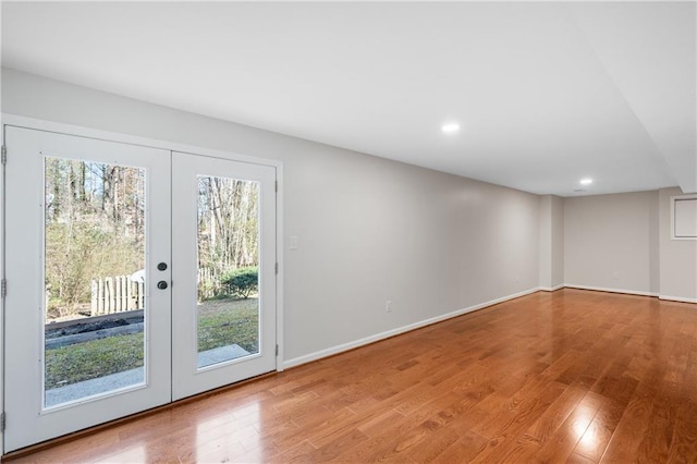 interior space featuring baseboards, french doors, recessed lighting, and light wood-style floors