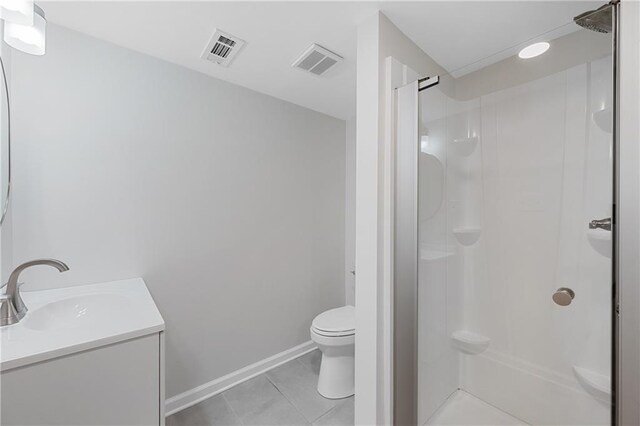 bathroom featuring a stall shower, visible vents, toilet, and tile patterned floors