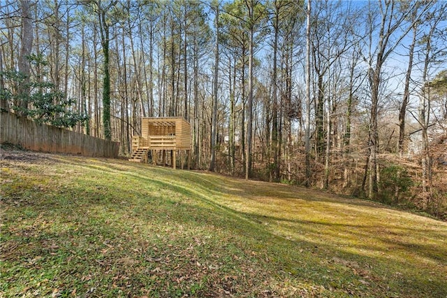 view of yard featuring stairs and fence