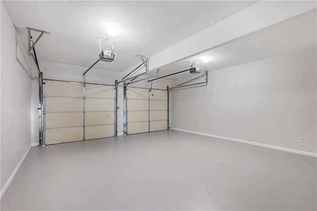 garage with baseboards and a garage door opener