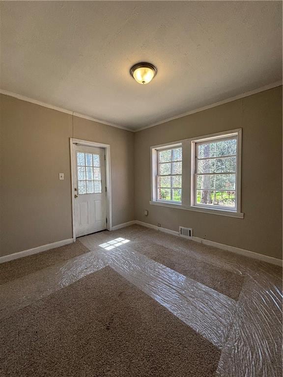 2103 River Rd, Ellenwood, GA 30294 - spare room with crown molding, plenty of natural light, and carpet flooring