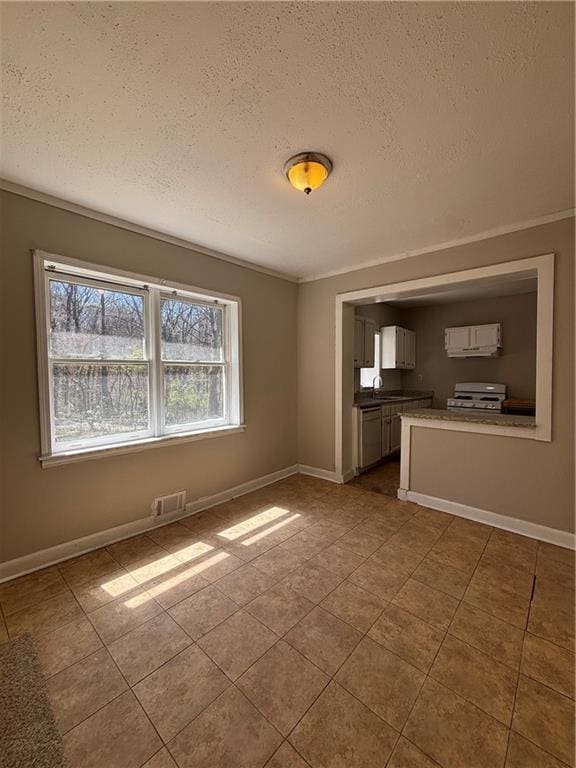 2103 River Rd, Ellenwood, GA 30294 - unfurnished living room featuring a textured ceiling, tile patterned floors, and crown molding