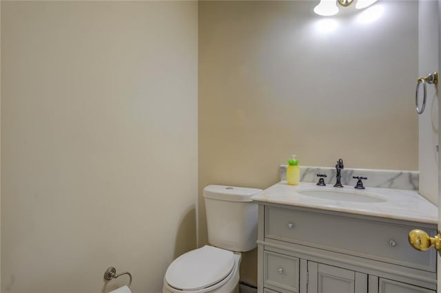 bathroom featuring toilet and vanity