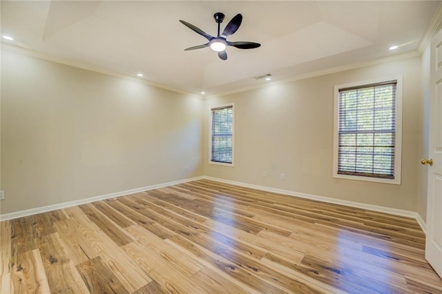 unfurnished room featuring baseboards, light wood-style floors, visible vents, and crown molding