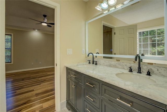 full bathroom with double vanity, wood finished floors, a sink, and visible vents