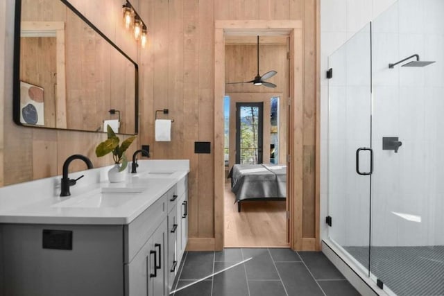 bathroom featuring vanity, walk in shower, tile patterned floors, and wood walls